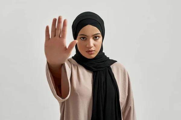 Serious young arabian woman in hijab showing stop — Foto Stock