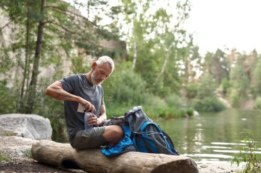 Middle aged caucasian man using pills for distillation water