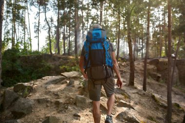 Selective focus on caucasian man with tourist backpack