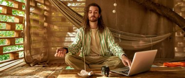 man tries to meditate and searches for the right music