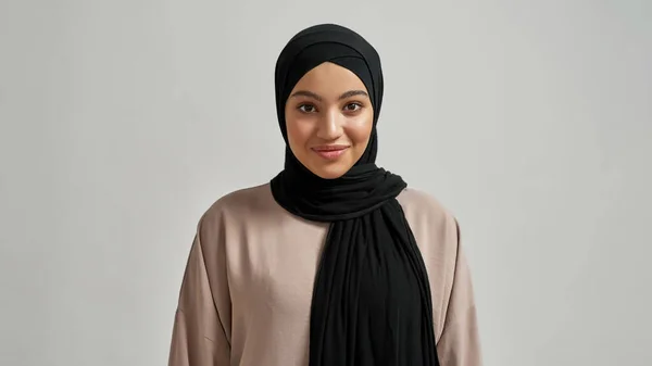 Portrait of cheerful young arabian girl in black hijab — Foto Stock