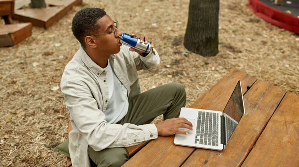 Young african american man with energy drink —  Fotos de Stock