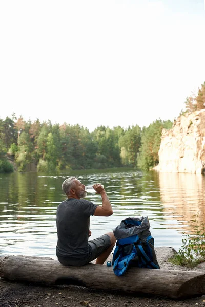 Rear view of middle aged caucasian man drinking water — Stock Photo, Image