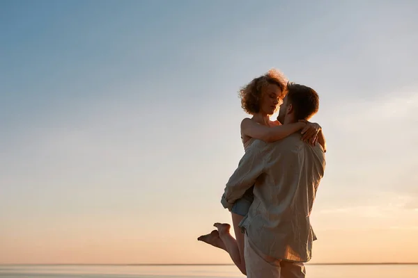 Happy young caucasian woman held by man — Stock Photo, Image