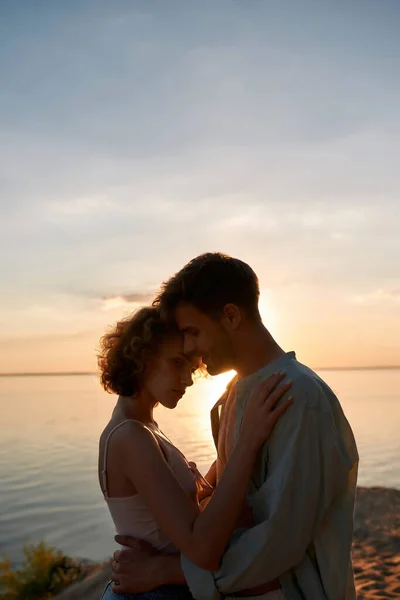 Portrait of young couple hugging each other at sunset — Stock Photo, Image