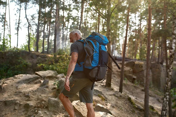 Happy middle aged caucasian man with tourist backpack — Stock Photo, Image