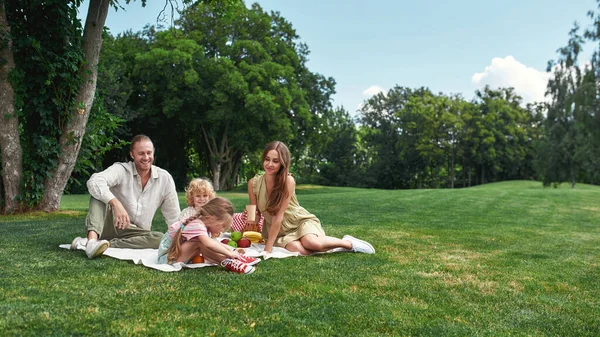 Lycklig familj koppla av tillsammans utomhus, ha picknick i naturen på en sommardag — Stockfoto