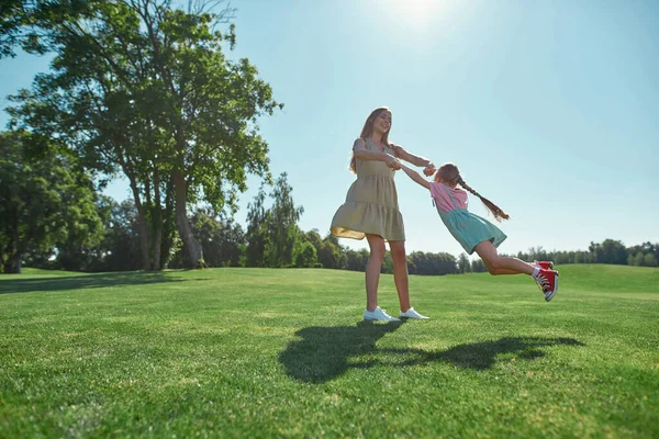 Plan complet de la mère et de la fille s'amusant ensemble sur le champ d'herbe dans le parc d'été — Photo