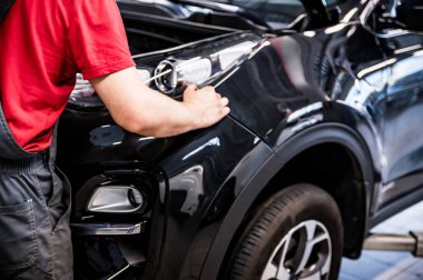 Ototalon 'da erkek araba tamircisi. Auto-ervice' de siyah araba işletme sınıfında.