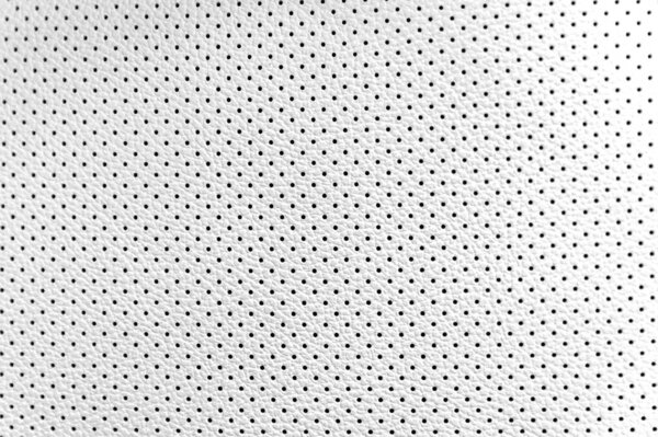 Close up of white leather texture with black holes