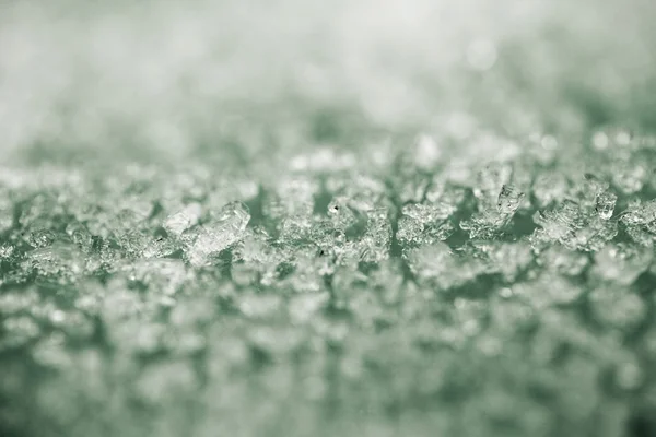 Tiny ice pieces on a plastic surface, winter background and texture — Stock Photo, Image