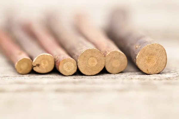 Still life composition with wooden sticks on an old wooden surface. Beautiful vintage composition — Stock Photo, Image