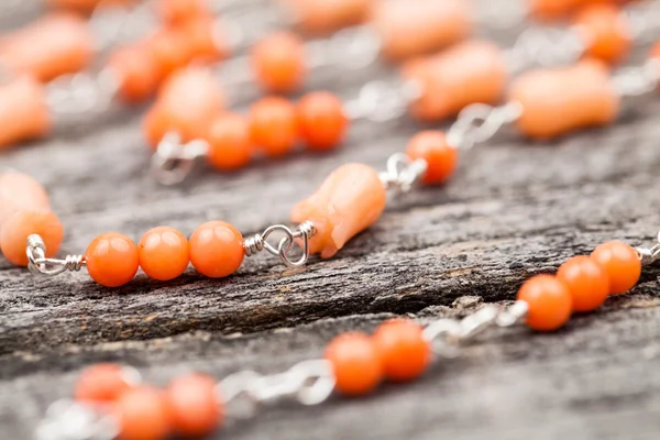 Silver jewels with colorful precious stones on a wooden surface — Stock Photo, Image