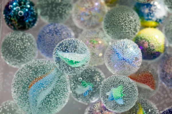 Abstract underwater composition with colorful glass balls, bubbles and light — Stock Photo, Image