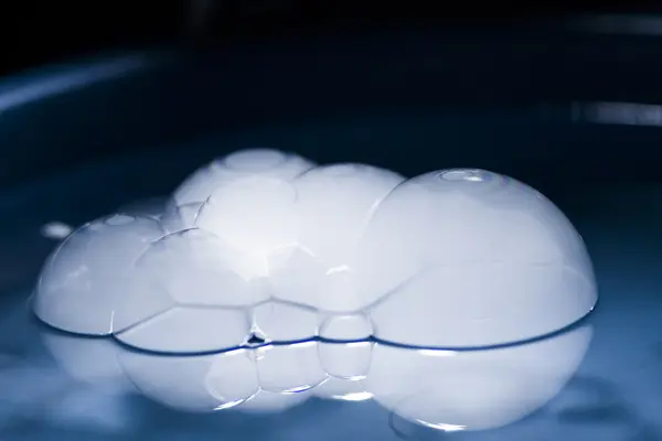 Abstract shot with big soap bubbles on a water surface with smoke inside — Stock Photo, Image