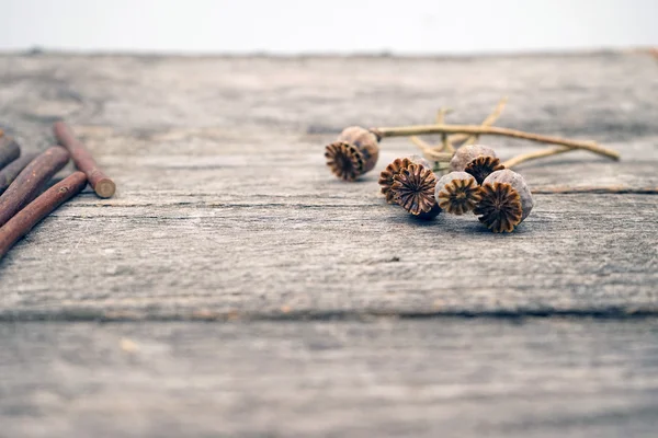 Vintage still life composition with poppy seeds on wooden surface — Stock Photo, Image