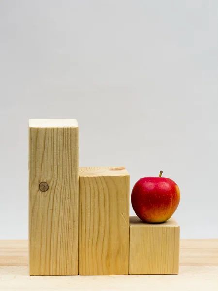 Wooden geometrical pieces with apples and light grey background — Stock Photo, Image