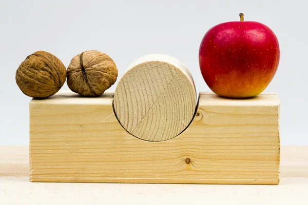 Wooden geometrical pieces with apples and light grey background — Stock Photo, Image