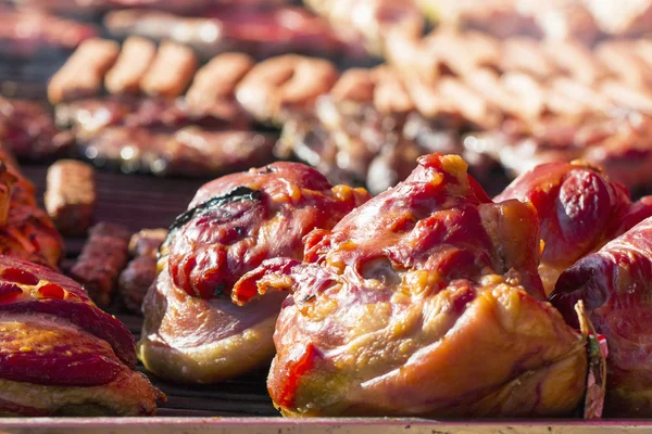 Diferentes tipos de carne grelhada e salsichas com fumaça e vapor da grelha — Fotografia de Stock