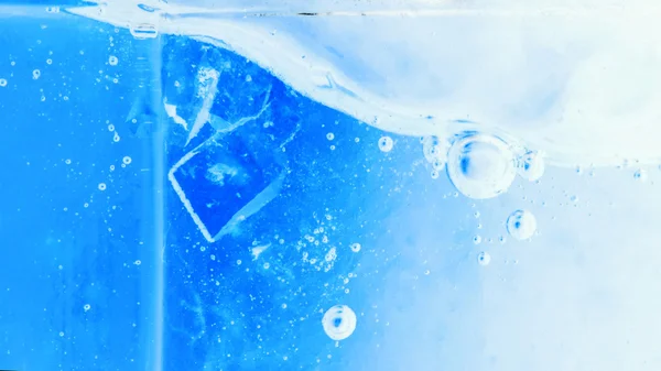 Abstract composition with sugar cubes in a jar with sweetness (inverted colors). It looks like water with bubbles and ice cubes — Stock Photo, Image