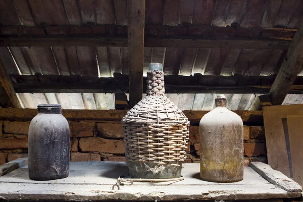 Glass, wooden and metallic objects in the attic with dust and spiderwebs in a beautiful, moody light