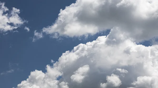 Nuvens bonitas, fofas, brancas e cinzentas e céu azul — Fotografia de Stock