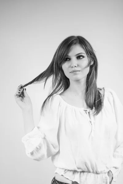 Beautiful caucasian girl wearing a white blouse with light grey background — Stock Photo, Image