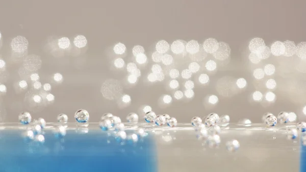 Abstract composition with underwater tubes with colorful jelly balls inside and bubbles — Stock Photo, Image