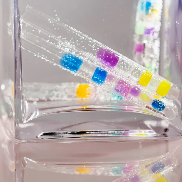 Abstract composition with underwater tubes with colorful jelly balls inside and bubbles — Stock Photo, Image