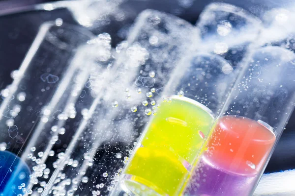 Abstract composition with underwater tubes with colorful jelly balls inside and bubbles — Stock Photo, Image