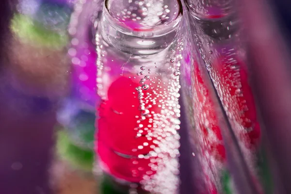 Abstract composition with underwater tubes with colorful jelly balls inside and bubbles — Stock Photo, Image