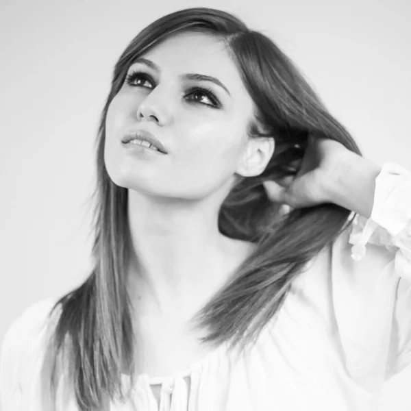 Beautiful caucasian girl wearing a white blouse with light grey background — Stock Photo, Image