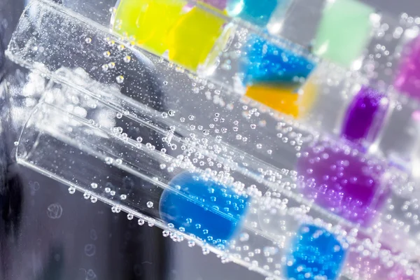 Abstract composition with underwater tubes with colorful jelly balls inside and bubbles — Stock Photo, Image