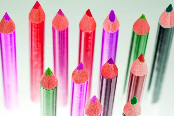 Group of sharp colored pencils with reflexions on dark background — Stock Photo, Image