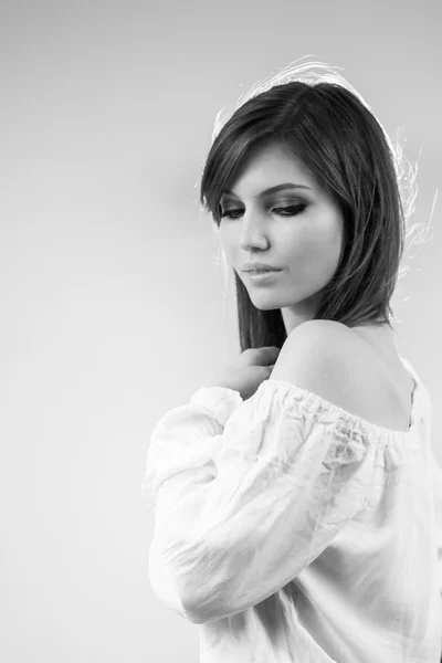 Black and white photo of beautiful caucasian girl wearing a white blouse — Stock Photo, Image