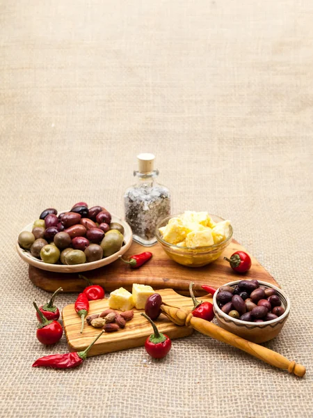 Composition with olive wood, olives, vinegar and spices with burlap texture — Stock Photo, Image