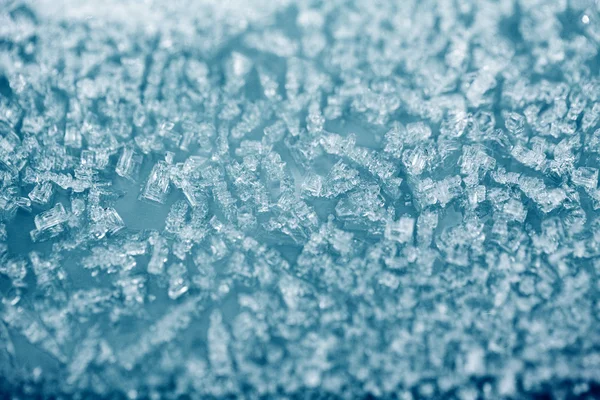 Tiny ice pieces on a plastic surface, winter background — Stock Photo, Image