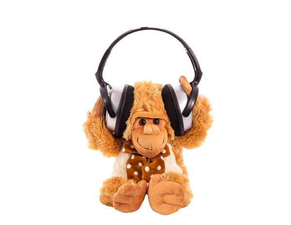 Soft toy a monkey in earphones — Stock Photo, Image