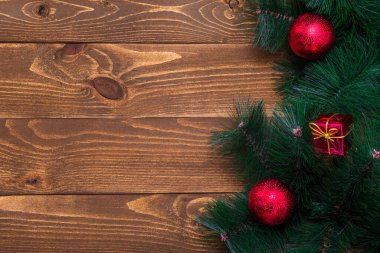 Süslü bir Noel ağacı dalına sahip ahşap bir arka plan. Yeni yıl konsepti. Uzayı kopyala Düz atış yapmak için masanın yüzeyi yatıyordu. Üst Manzara. Doğal ham planlı ahşap.