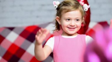 Küçük güzel kız kalp şeklinde pembe bir balonla oynuyor. Sevgililer Günü tatili. Çocuk sevgisi. Mutlu çocuk doğum gününü kutluyor, kadınlar ve anneler gününü kutluyor..