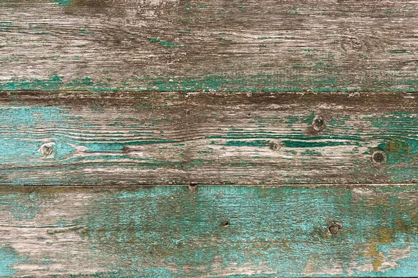 Old brown-blue wooden background with peeling paint and green mildew. Natural wood in grunge style. Top view. Raw planed texture of coniferous pine. Surface of table to shoot flat lay. Copy space. — Stock Photo, Image