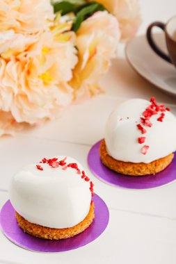 White heart shaped mousse cakes in glaze