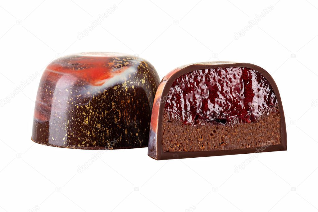 Cut luxury handmade bonbon with chocolate ganache and berry or fruit purees filling isolated on white background. Exclusive handcrafted colorful candies. Product concept for chocolatier