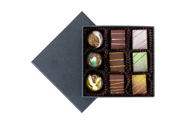 Sortiment Von Luxus Bonbons Mit Bunten Spritzern Schwarzer Box Isoliert lizenzfreie Stockbilder