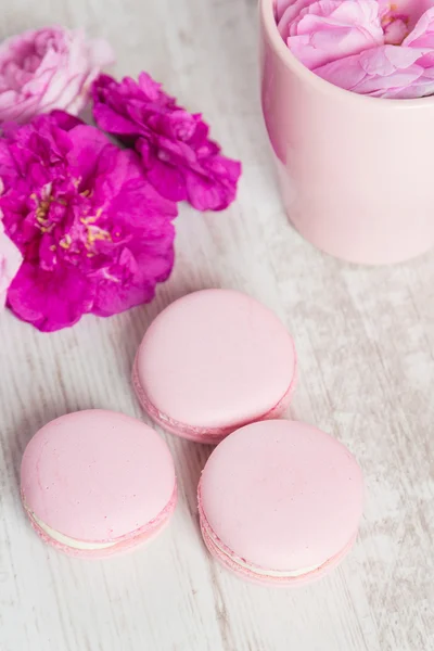 Macarrones rosados tiernos sobre fondo de madera blanca — Foto de Stock