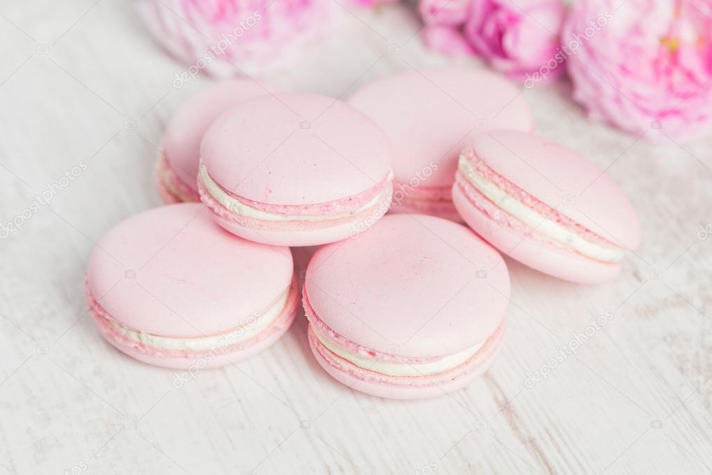 Pastel pink macaroons with rose, selective focus