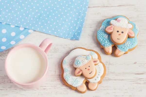 Two cute gingerbread sheep with cup of milk