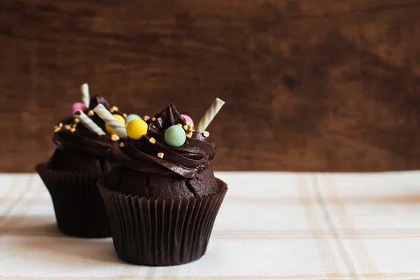 Chocolate cupcakes no fundo de madeira rústica — Fotografia de Stock