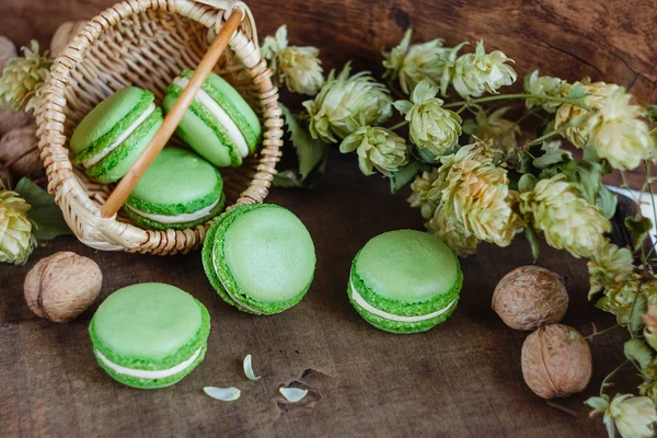 Green macaroons on dark wooden background — Stock Photo, Image