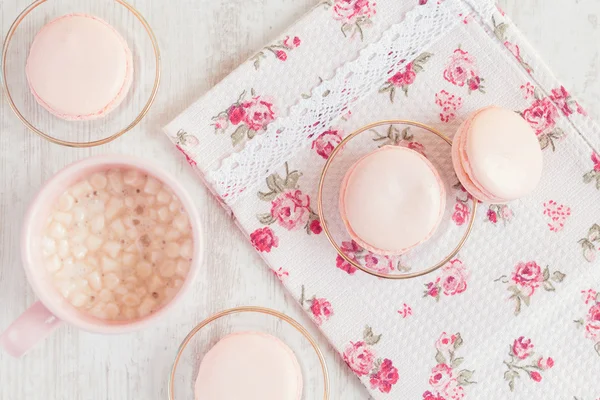 Pink macaroons in gift box with cup of coffee — Stock Photo, Image